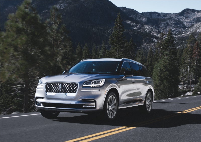 A 2023 Lincoln Aviator® Grand Touring SUV being driven on a winding road to demonstrate the capabilities of all-wheel drive | Central Florida Lincoln in Orlando FL